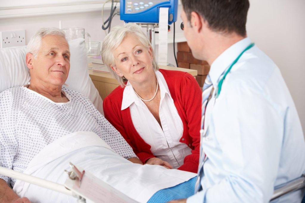 Assertive Woman listening to doctor explaining her husband's illness. 